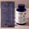 Multivitamin bottle labeled 'Higher Nature' with a product information sheet on a neutral background