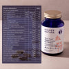 A bottle of Higher Nature True Food Multivitamin for Women next to a printed product information table on a white background.